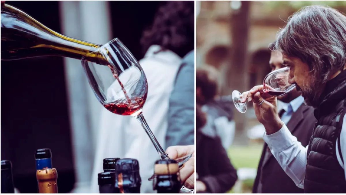Vino tinto servido en una copa y una persona oliendo su copa